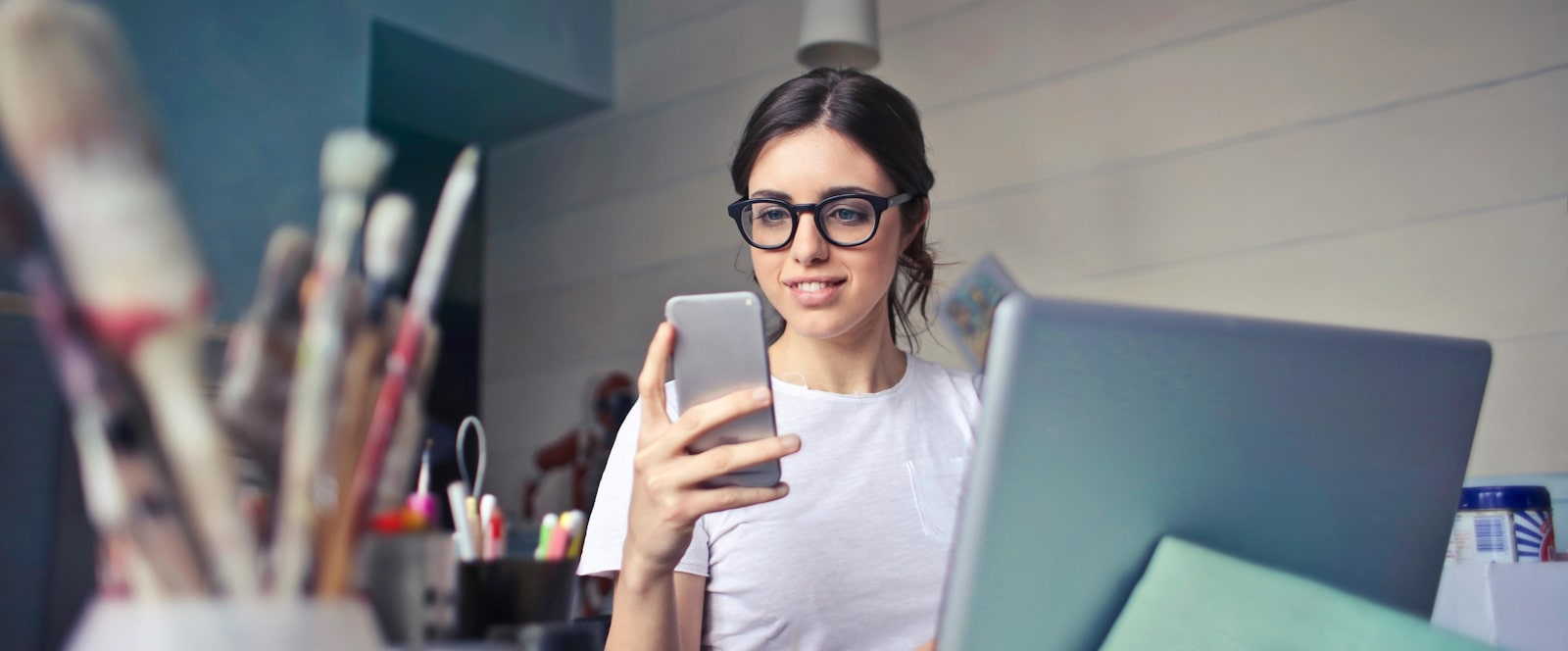 woman with laptop and cell phone