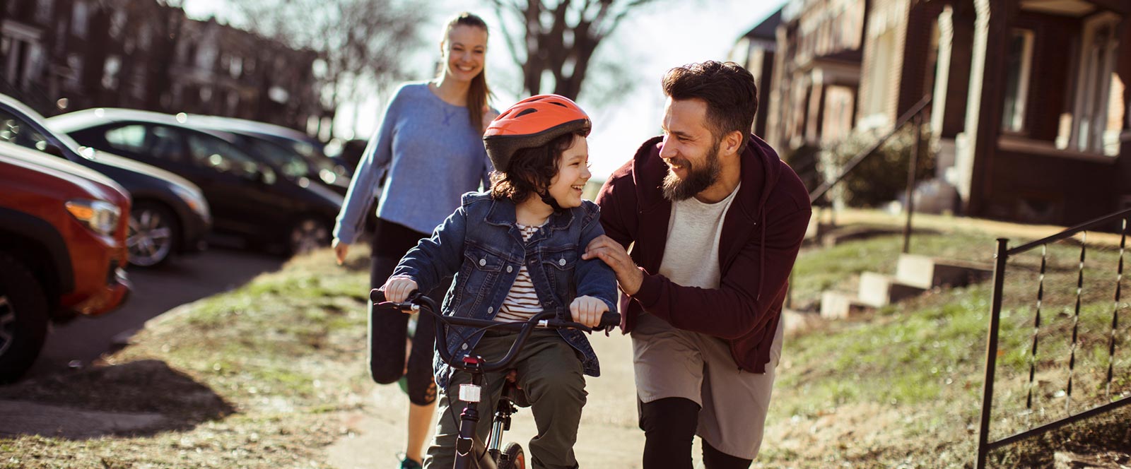 Family riding bike in sidewalk