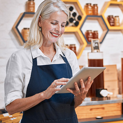 Business woman working on tablet in shop