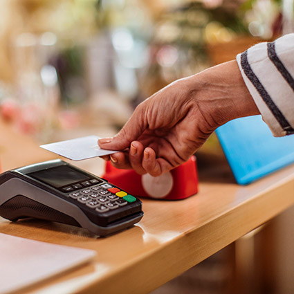 Close up of person paying with RFID debit card